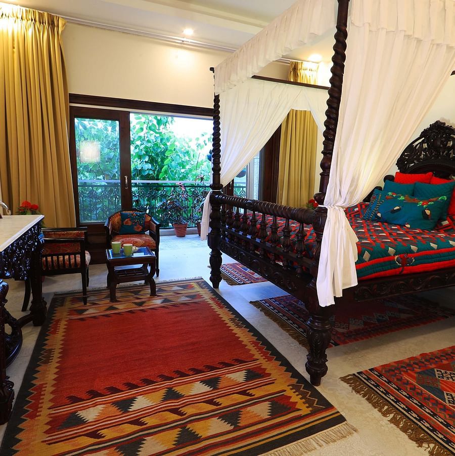  A bedroom with a four-poster bed and a view of the outdoors.